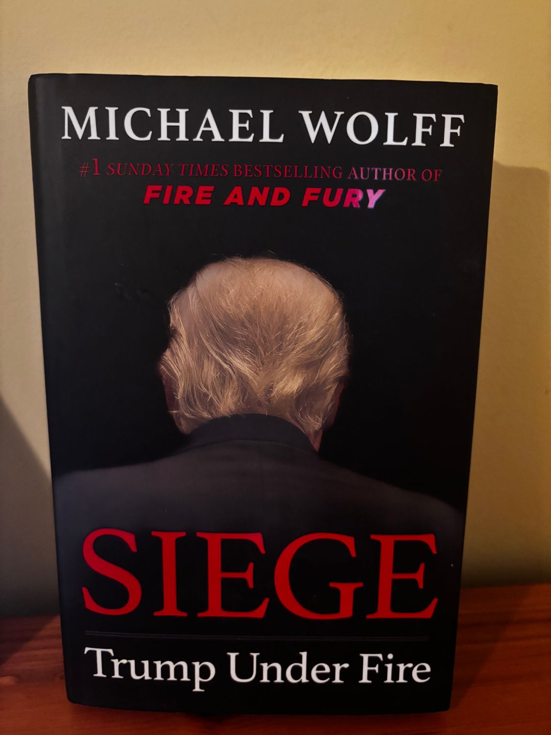 Explore political intrigue with the pre-loved Siege: Trump Under Fire Hardcover by Michael Wolff, a must-have read!