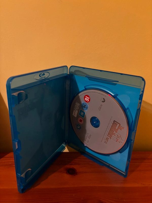 The Godfather Coppola Restoration [Blu-ray] [1972] [Region Free] displayed inside a blue case, perfect for collectors.
