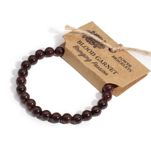 Power Bracelet - Blood Garnet showcasing deep red beads, perfect for uplifting mood and enhancing any outfit.