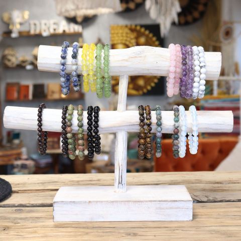 Stylish Power Bracelet - Tiger Eye displayed on a wooden stand, perfect for enhancing any outfit.