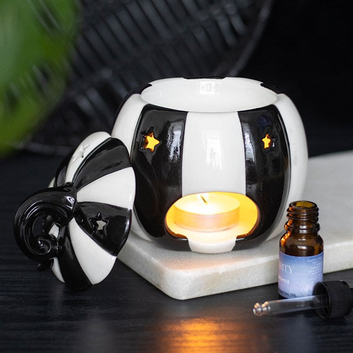 Enhance your home with this Black and White Striped Pumpkin Oil Burner, perfect for creating a cosy atmosphere.
