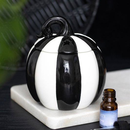 Enhance your home with the Black and White Striped Pumpkin Oil Burner, perfect for creating a cosy, aromatic atmosphere.