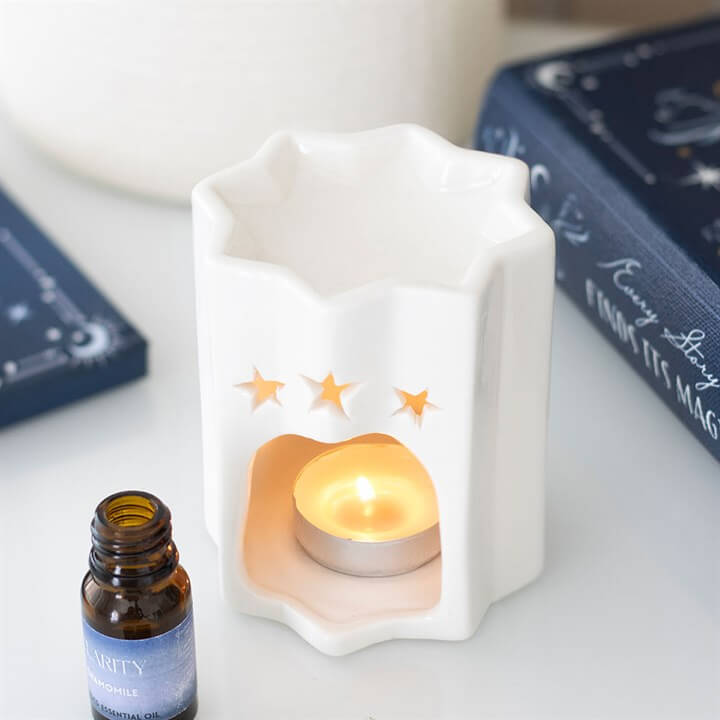 White Star Shaped Oil Burner For Fragrance Oil Decorative Tea Light Holder And Gift Idea with tea light and essential oil.
