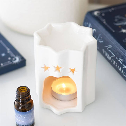 White Star Shaped Oil Burner For Fragrance Oil Decorative Tea Light Holder And Gift Idea with tea light and essential oil.