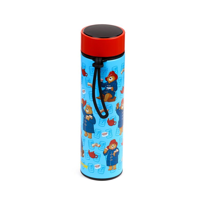 Paddington Bear-themed insulated drinks bottle with red lid and black strap on blue patterned body.