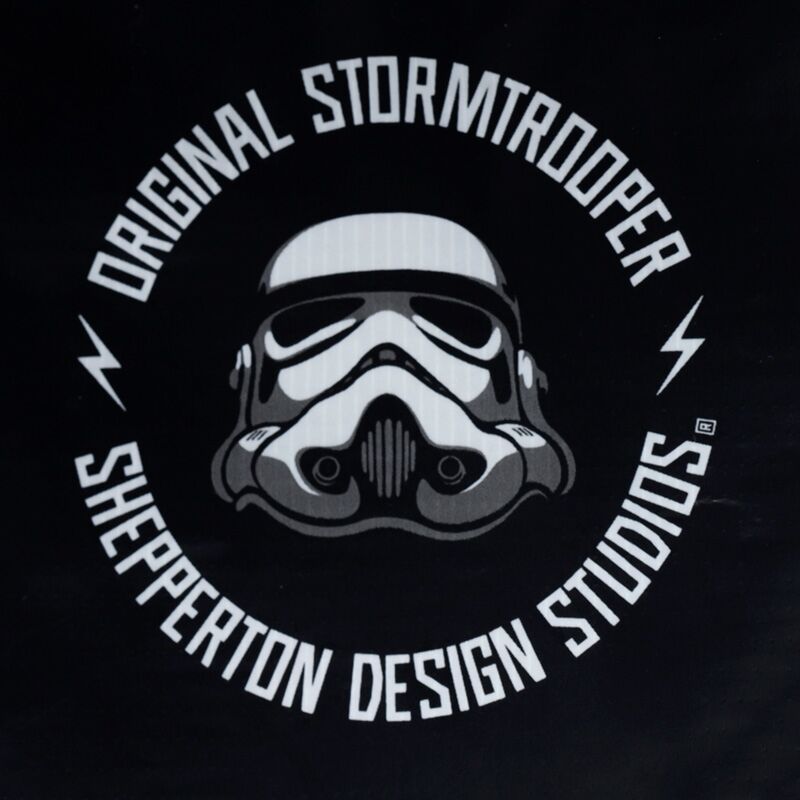 Circular badge logo featuring a Stormtrooper helmet with Original Stormtrooper and Shepparton Design Studios on black background.