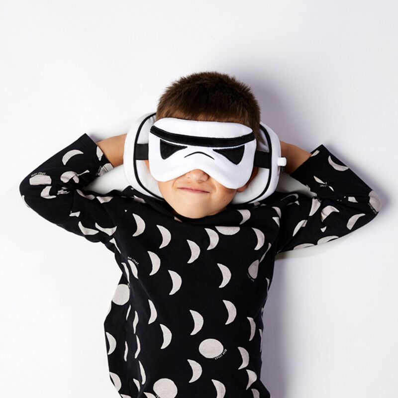 Child wears Original Stormtrooper eye mask from Relaxeazzz Travel Pillow & Eye Mask set.