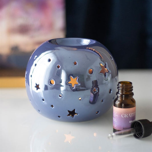 Purple Iridescent Star Oil Burner and Wax Warmer, casting a mystical glow with star cut-outs for a whimsical touch.
