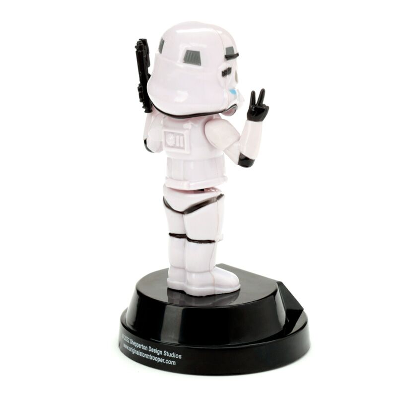 Solar Pal Stormtrooper figurine on black pedestal, peace-sign pose, solar-powered desk collectible.