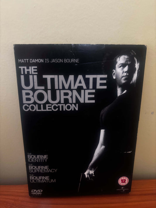 DVD box set titled 'The Ultimate Bourne Collection' on a beige surface.