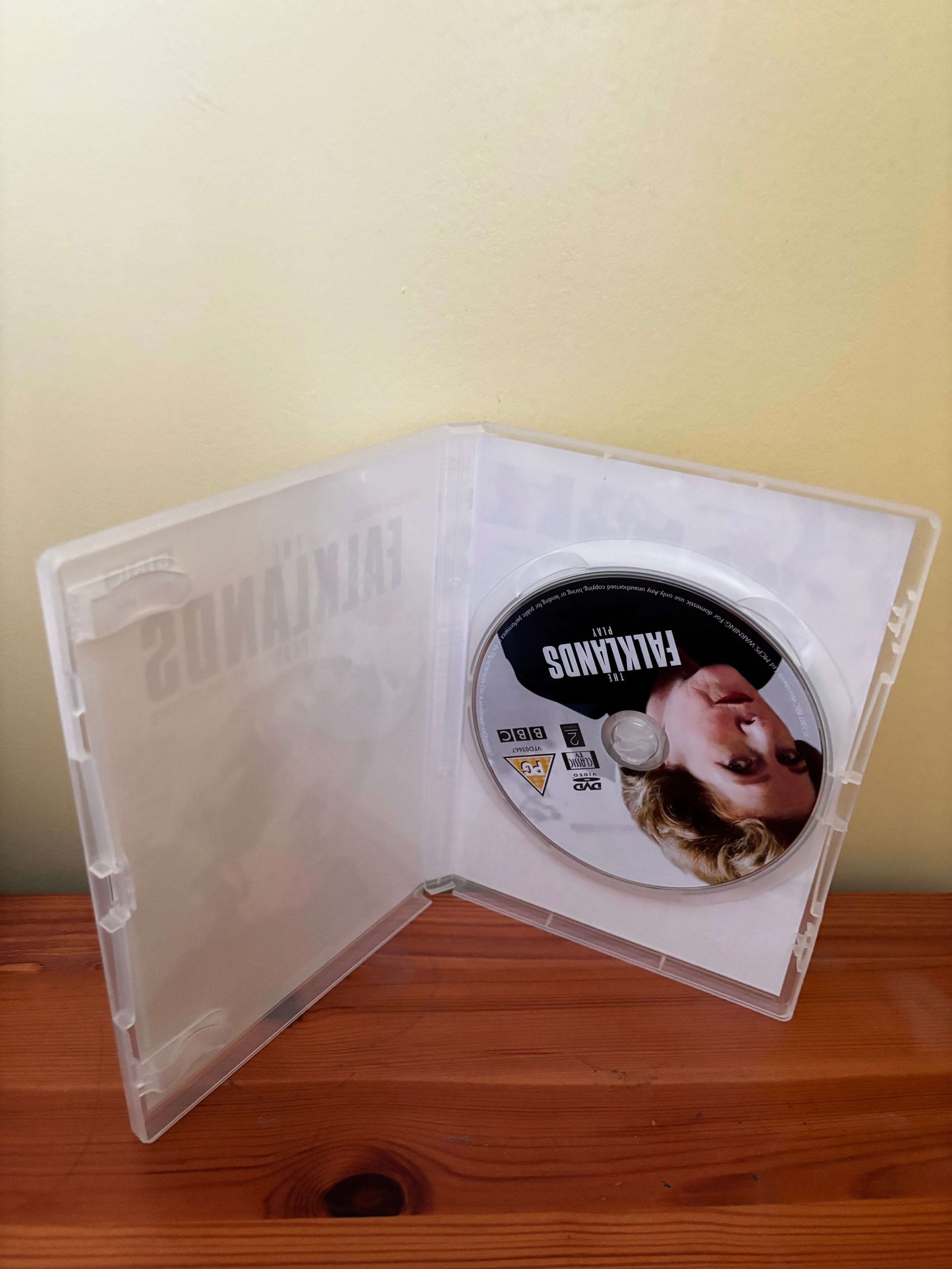 DVD case with a disc featuring a face on a plain background