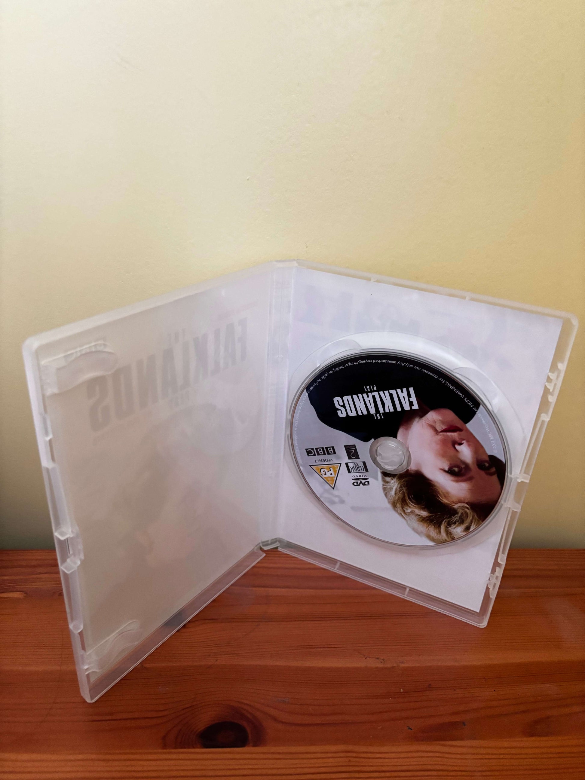 DVD case with a disc featuring a face on a plain background