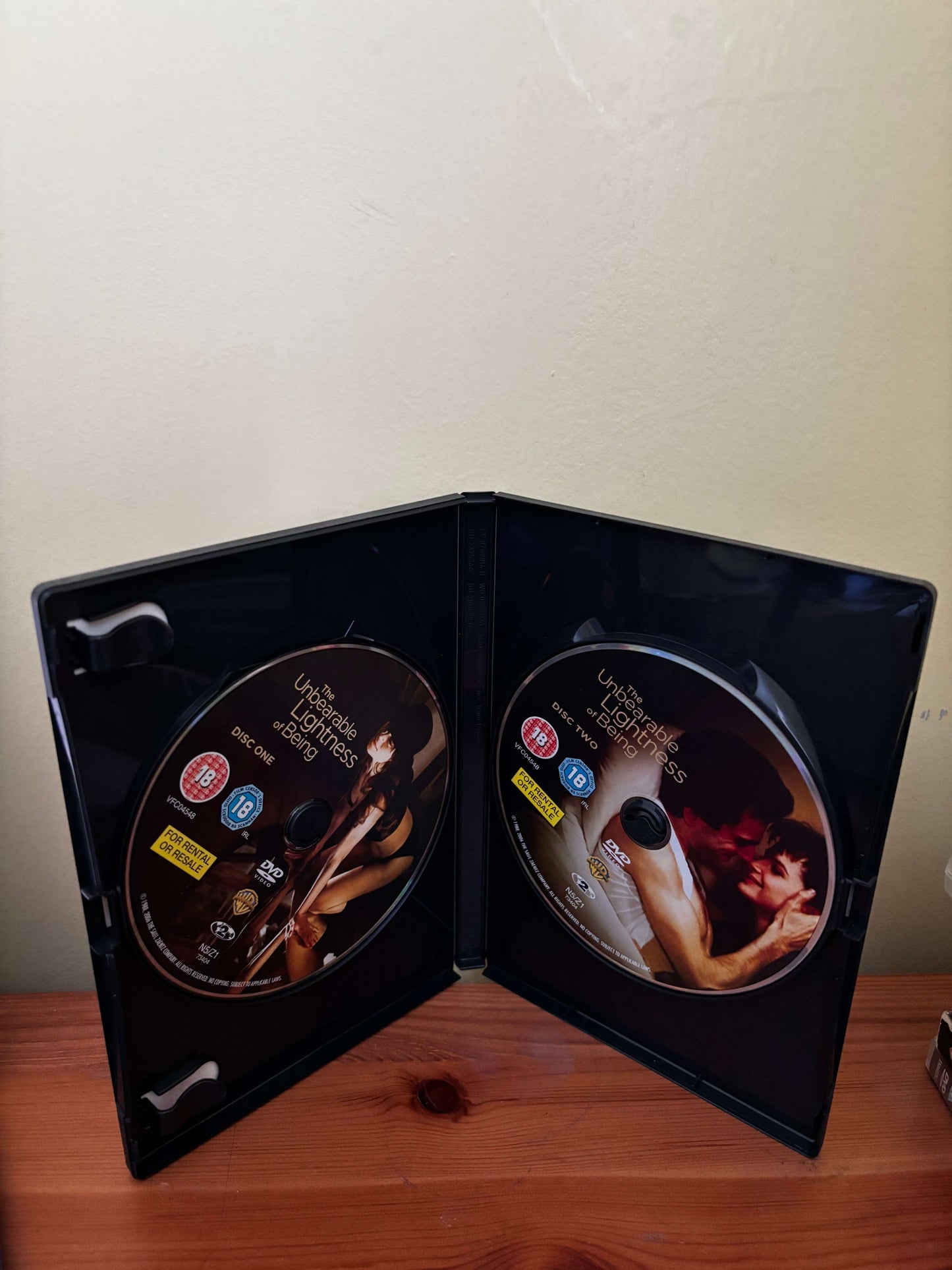 Two DVD covers with a couple on a wooden surface