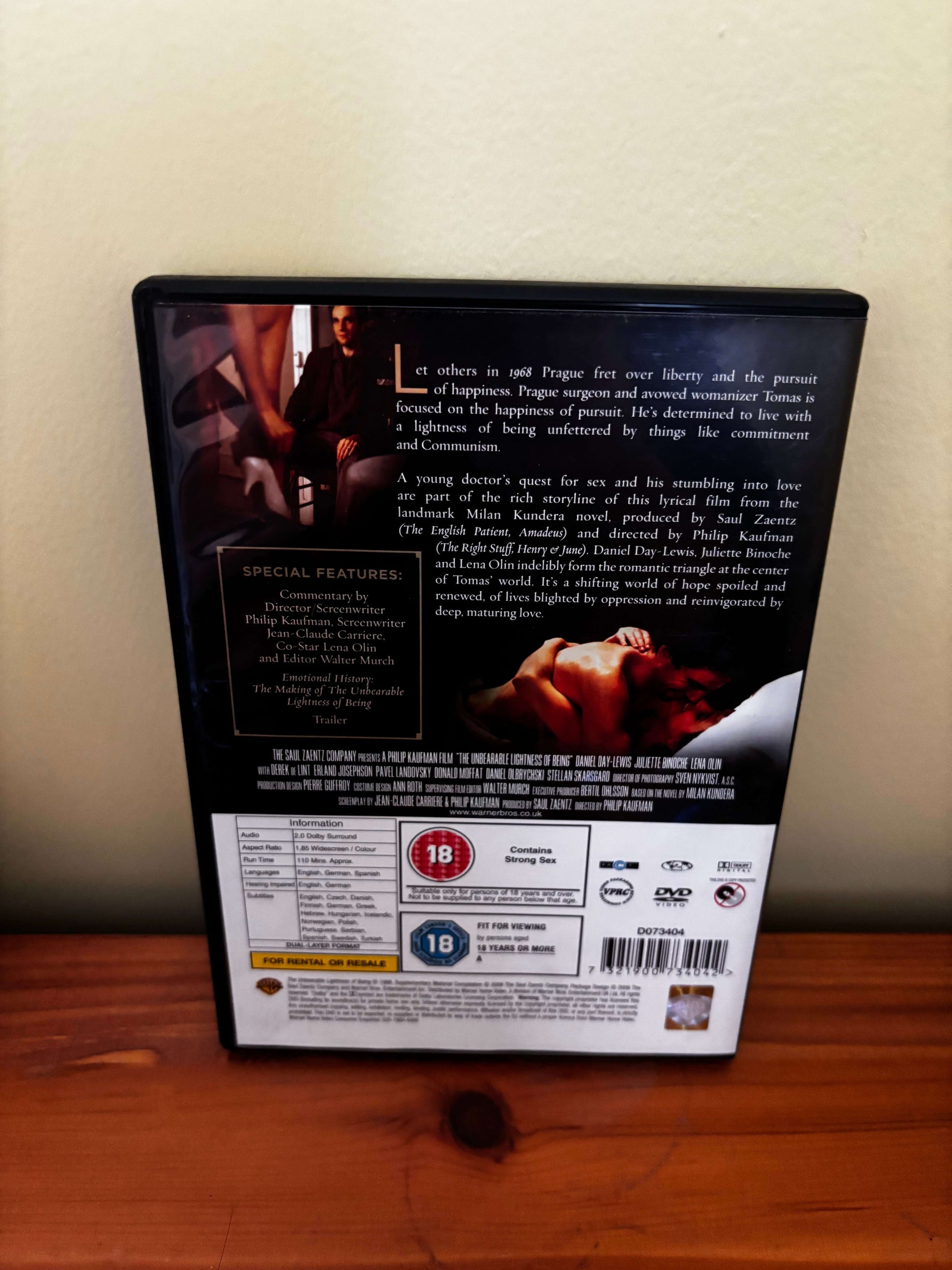 DVD case with movie scenes on a wooden surface