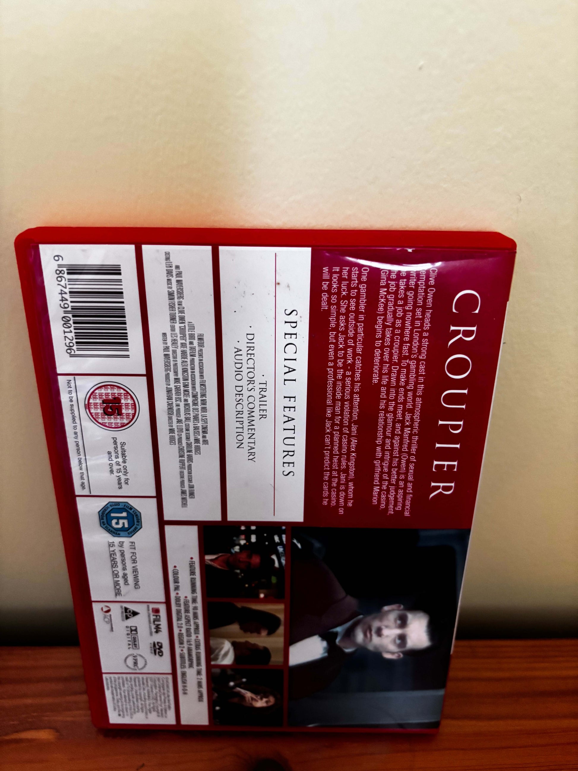 DVD cover of 'Croupier' with text and images on a beige wall.