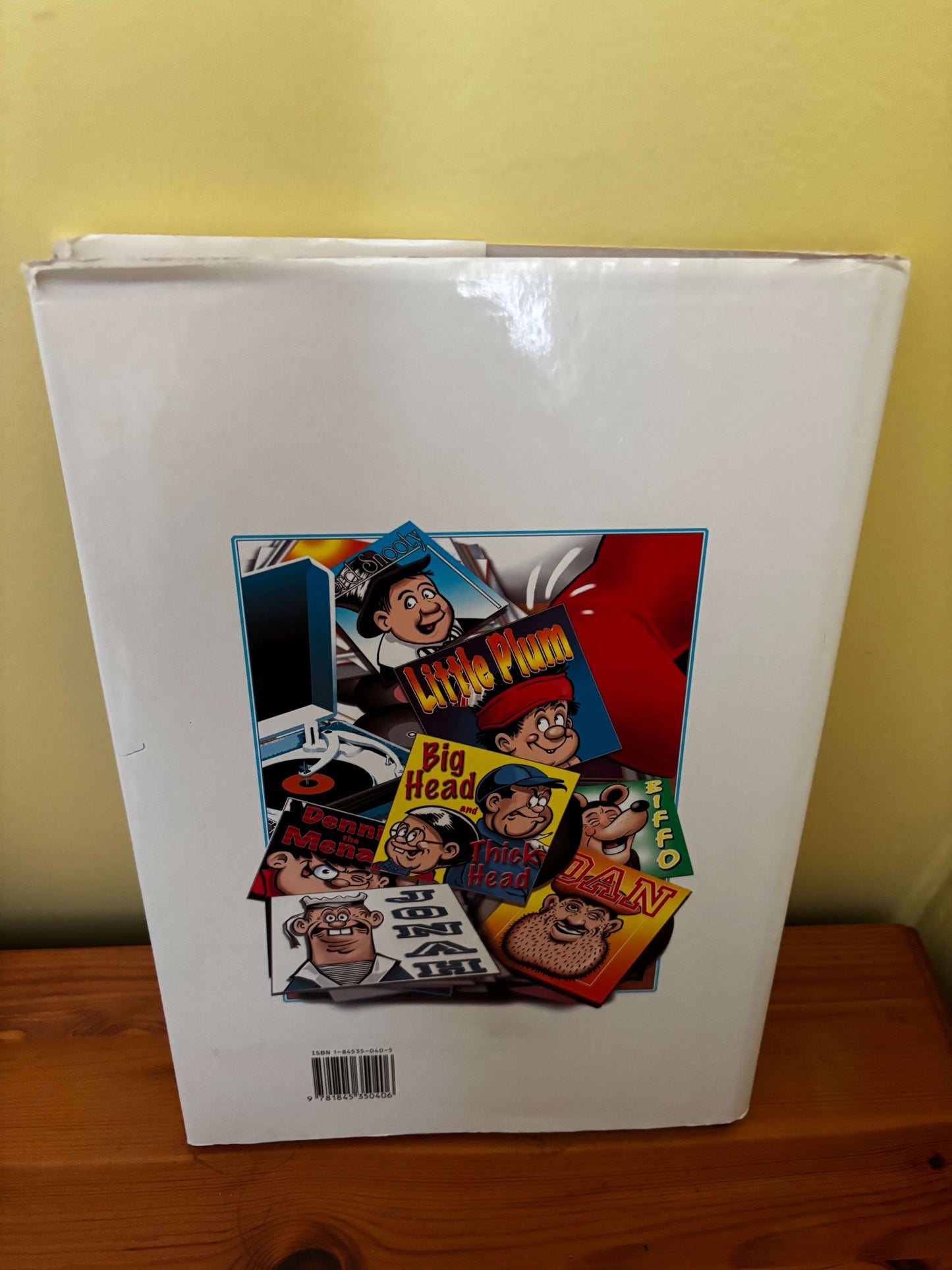 Book with a colorful cover featuring various characters on a white background