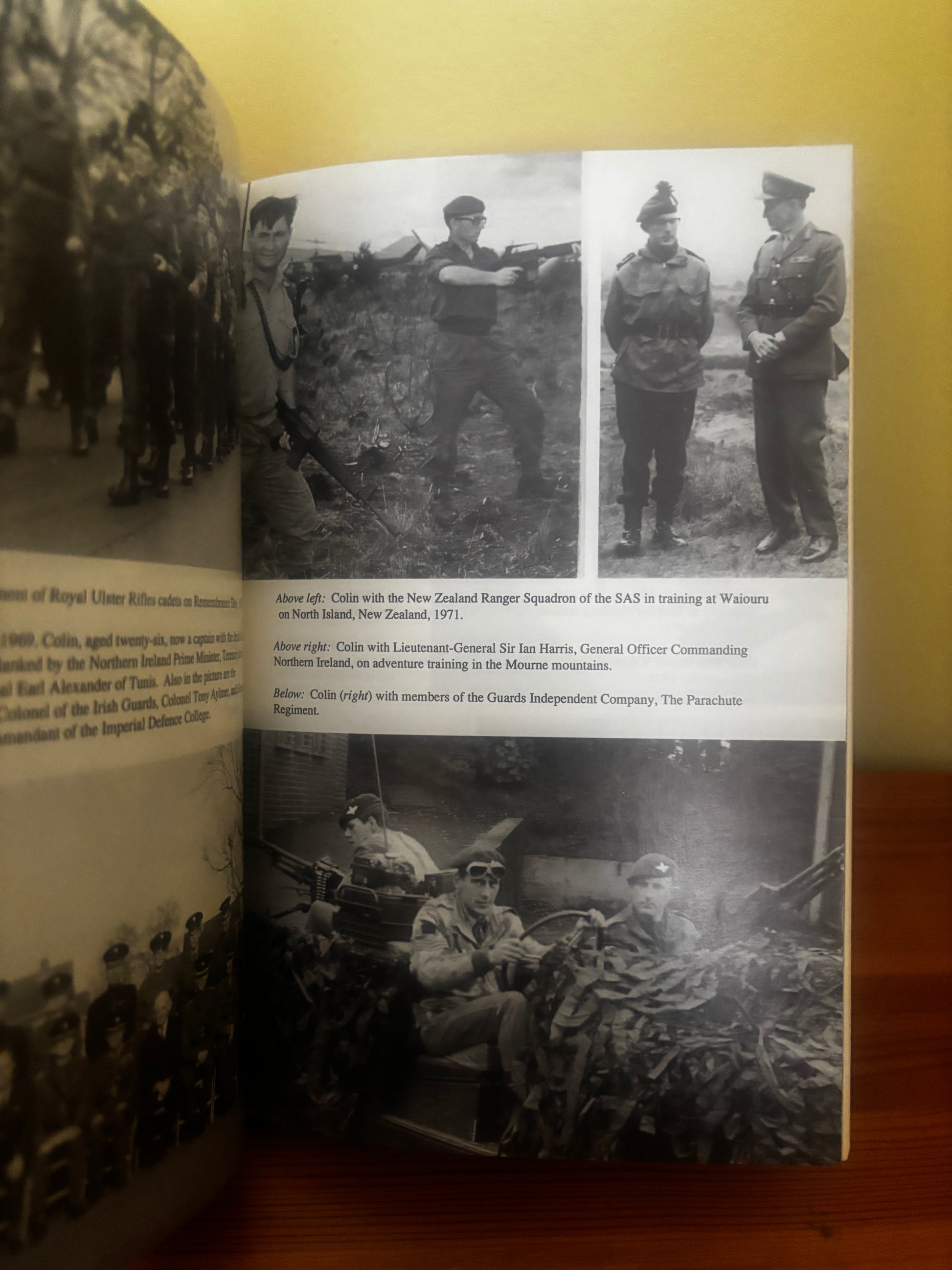 Open book with black and white photographs on a wooden surface