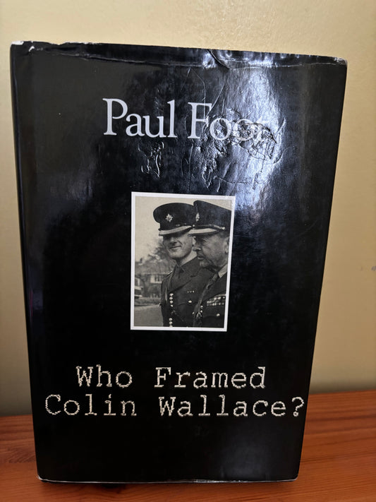 Book titled 'Who Framed Colin Wallace?' with a black cover and portrait of two men in uniform.