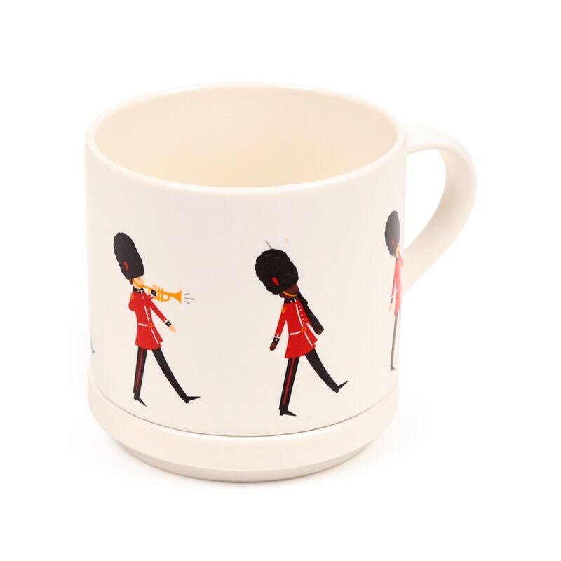 Porcelain mug with marching London Guardsman design and coaster lid, a classic British souvenir.