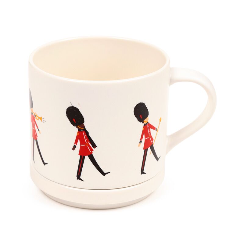 Porcelain mug with London Guardsman souvenir motif in red coats on white glaze.