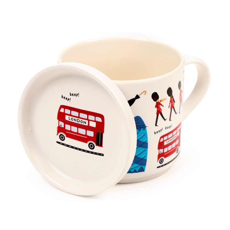 Porcelain mug with lid featuring London landmarks, including a red double-decker bus.