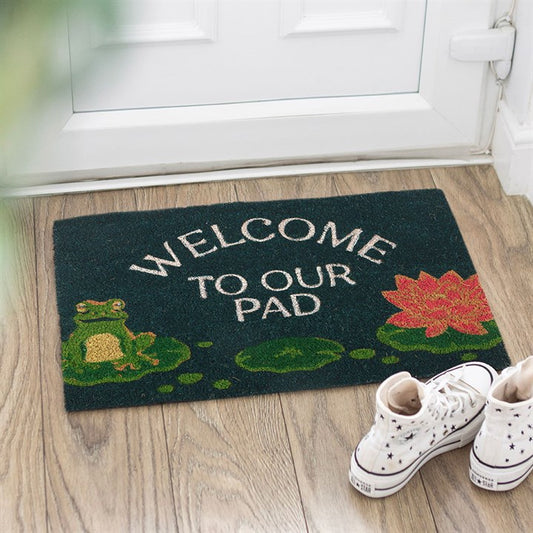 Charming Welcome to Our Pad Doormat featuring a frog and lily pad design, perfect for greeting guests at your home.