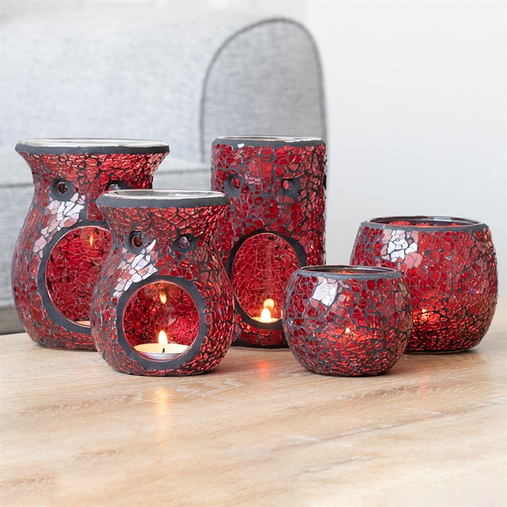 Set of large red crackle glass oil burners and wax warmers with circular openings and lit tea lights.