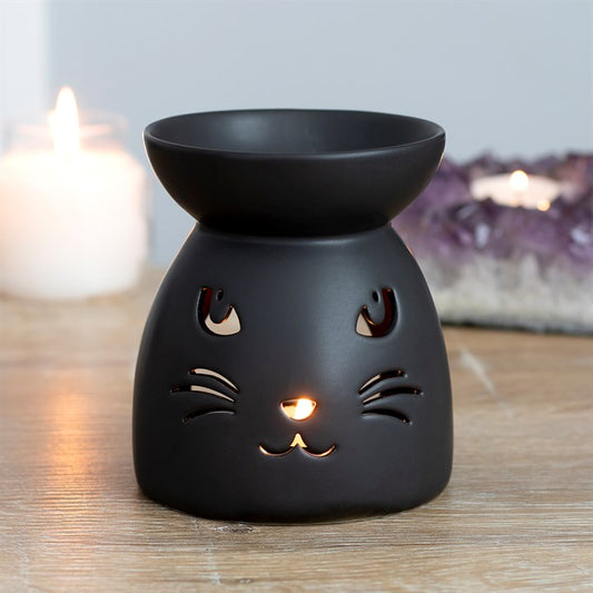 Black Cat Cut Out Oil Burner and Wax Warmer, matte black ceramic with cat-face cutouts and a warm glow.