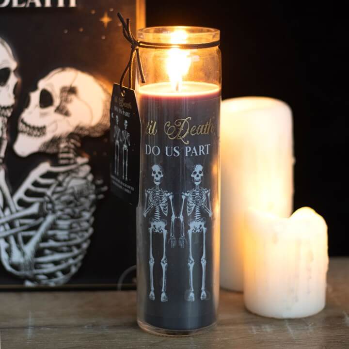 Til Death Do Us Part Amber Noir Tube Candle With Skeleton Couple Design in a dimly lit setting.