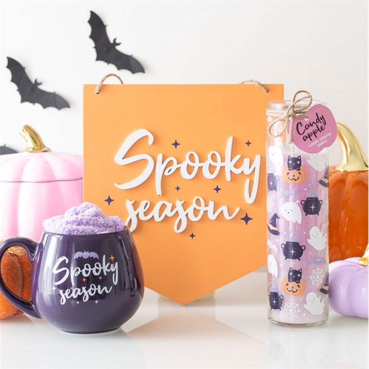 Delight in the Spooky Season Mug and Socks Set, featuring a purple mug and lilac fluffy socks for Halloween warmth.