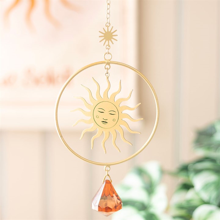 Brighten your space with the Golden Hour Crystal Suncatcher, featuring an elegant sun design and vibrant orange crystal.