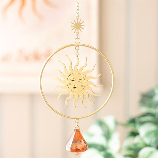 Brighten your space with the Golden Hour Crystal Suncatcher, featuring an elegant sun design and vibrant orange crystal.