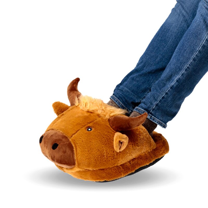 Plush Maxi Slipper Foot Warmer Highland Coo worn by person in jeans.