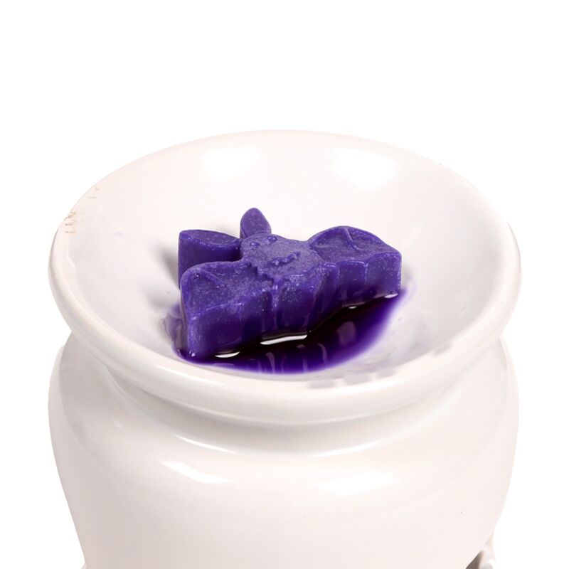 Purple star-shaped wax melt from Handmade Wax Melt Set of 5 - Spooky, in a white ceramic dish.
