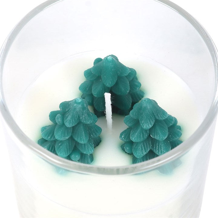 Winter Wonderland Candle with Tree Scene: teal tree-shaped wax decorations around a central wick in unscented paraffin.