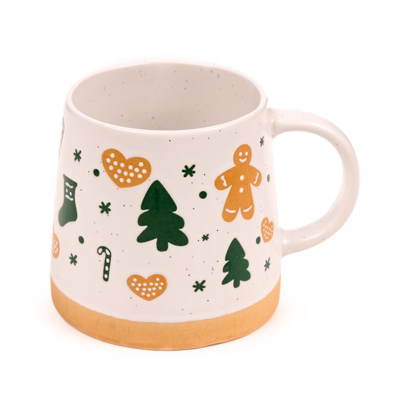 Stoneware mug with gingerbread man and Christmas motifs in green and orange on white speckled glaze with a tan base.