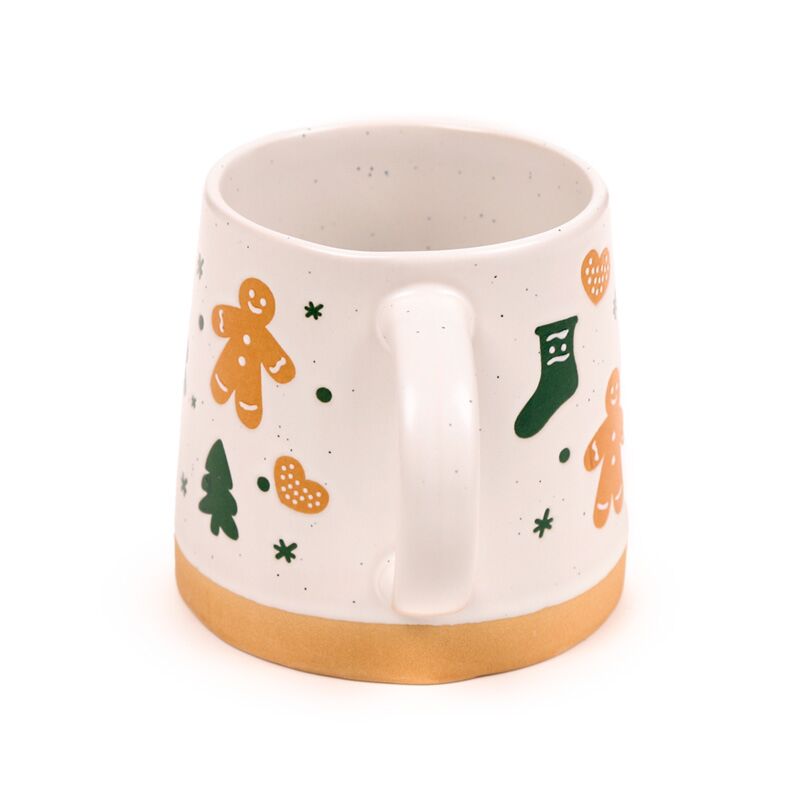 Stoneware mug with gingerbread man motif and festive Christmas decorations, white glaze with a gold rim.