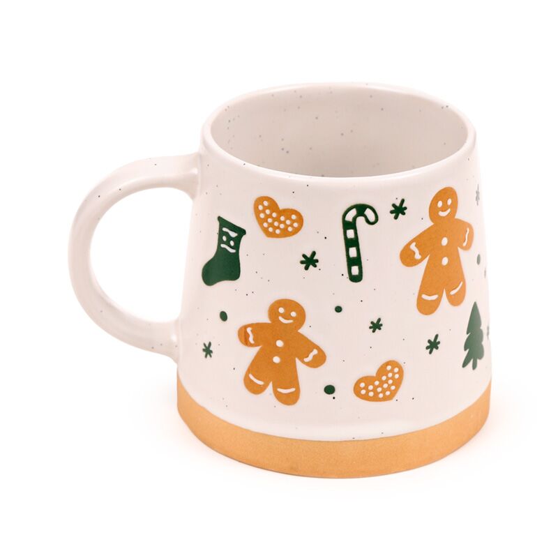 Stoneware mug featuring orange gingerbread men, candy canes, hearts and trees on white with an orange base.