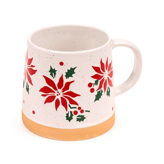 Stoneware mug with red poinsettia and holly on speckled white glaze, tan base.