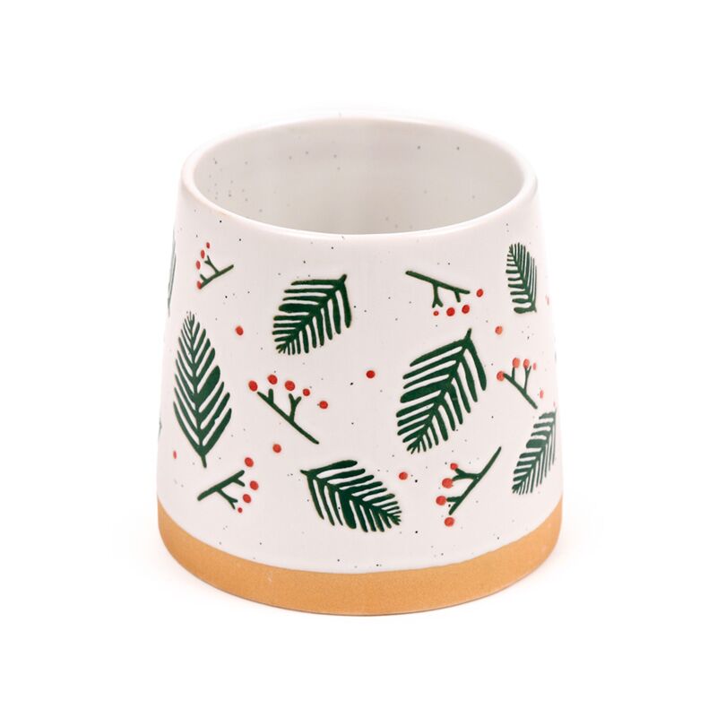 Stoneware mug featuring pine sprigs and red berries on white with a natural tan base.