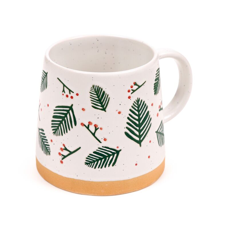 Stoneware mug with pine sprigs and red berries on a white speckled glaze with a tan base.