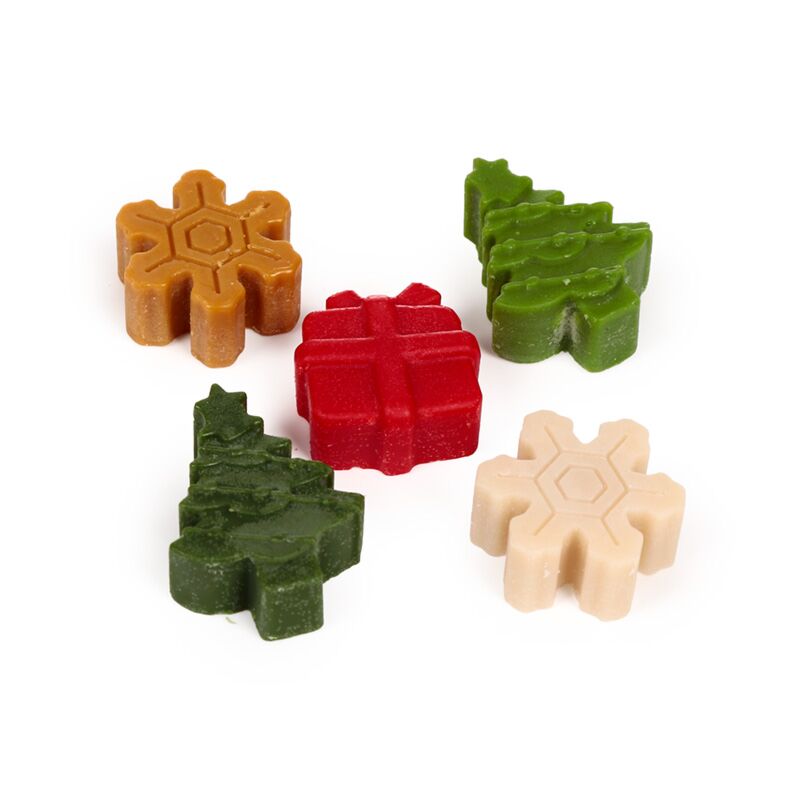 Five handmade wax melts in Winter Spice Christmas Botanicals, snowflake shapes in orange, red, green and cream.