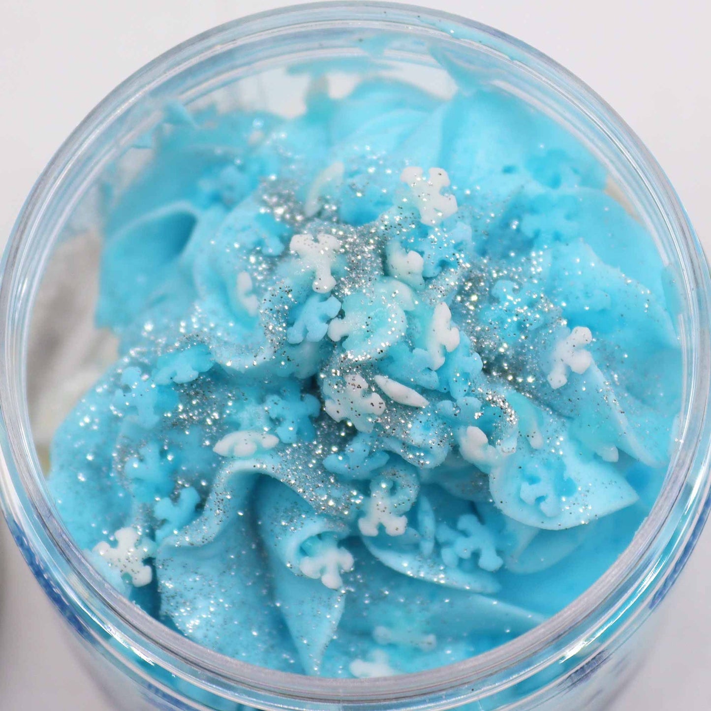 White Christmas Whipped Soap 120g: vibrant blue whipped soap with white snowflakes and silver glitter in a jar.
