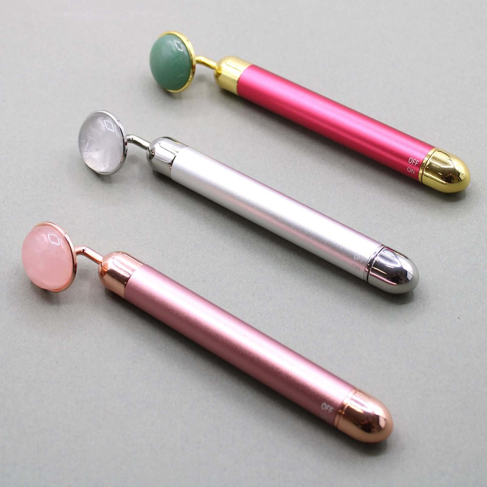 Gemstone Vibration Pad Jade Facial Massager With Gold Trim in various colors including green, pink, and white.