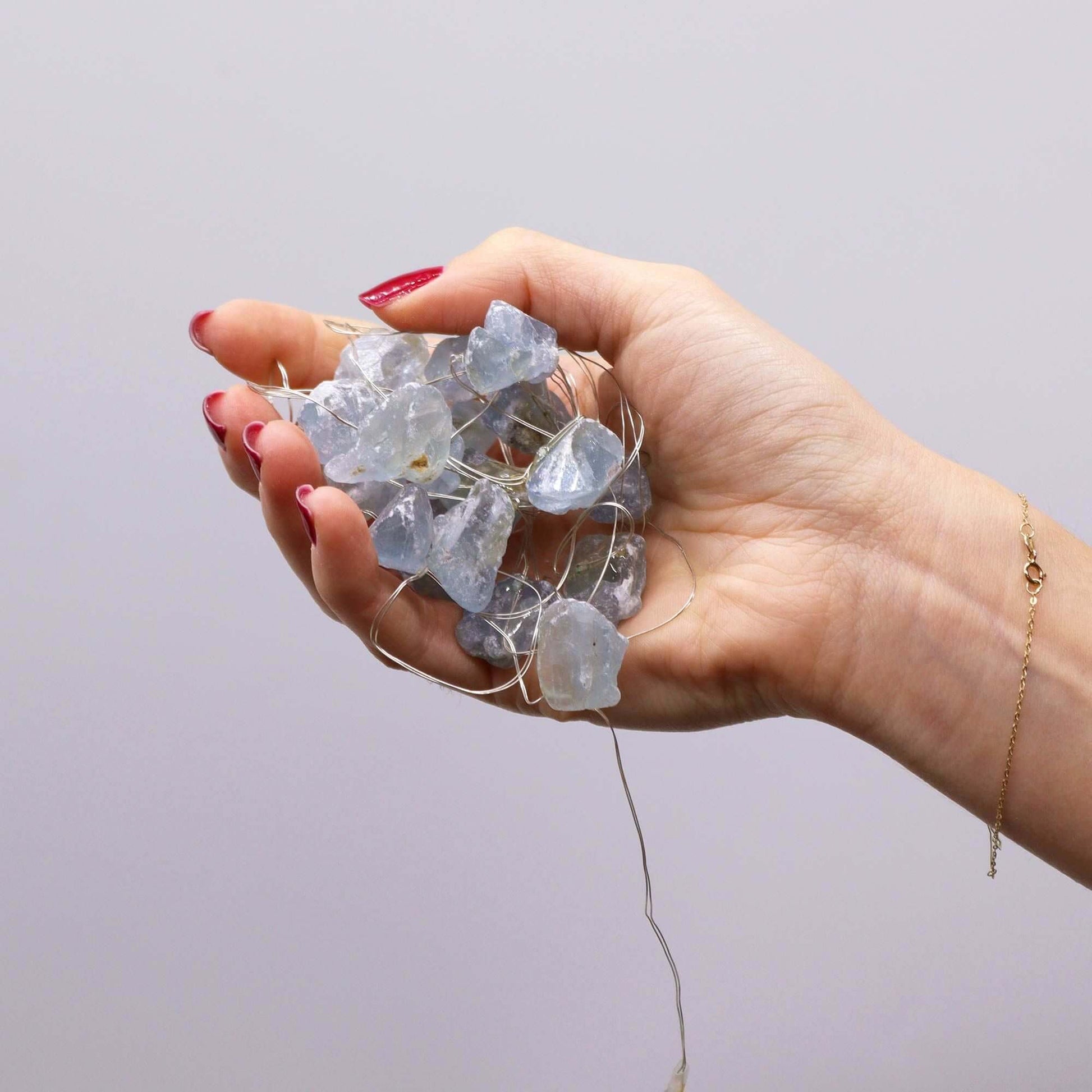 Celestite Gemstone Enchantment Lights USB Powered With Celestite Crystals held in a hand.
