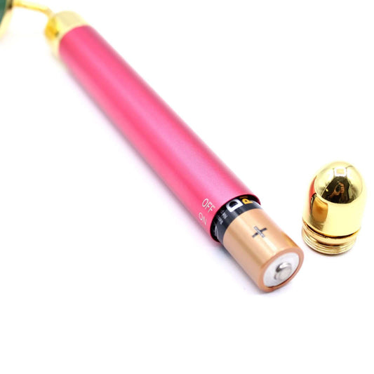 Gemstone Vibration Pad Jade Facial Massager With Gold Trim showing battery compartment and gold trim details.