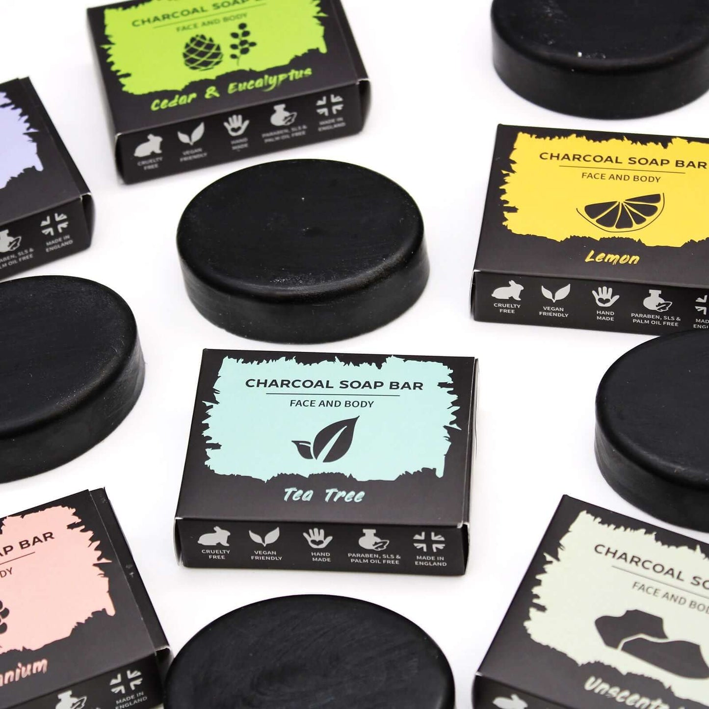 Charcoal Soap 85g - Tea Tree surrounded by other charcoal soap varieties on a flat surface.