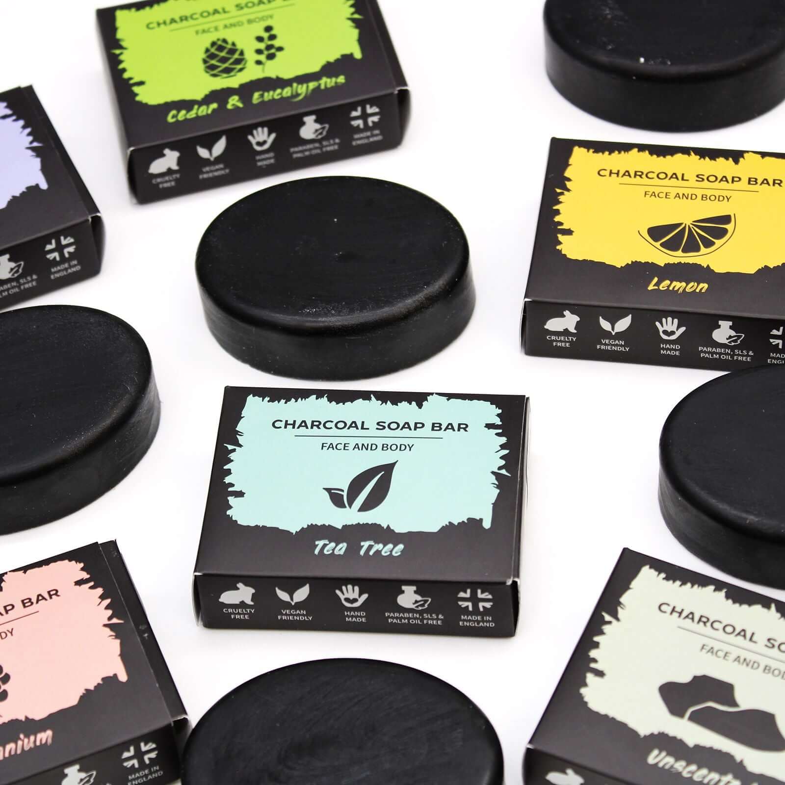 Charcoal Soap 85g - Tea Tree surrounded by other charcoal soap varieties on a flat surface.