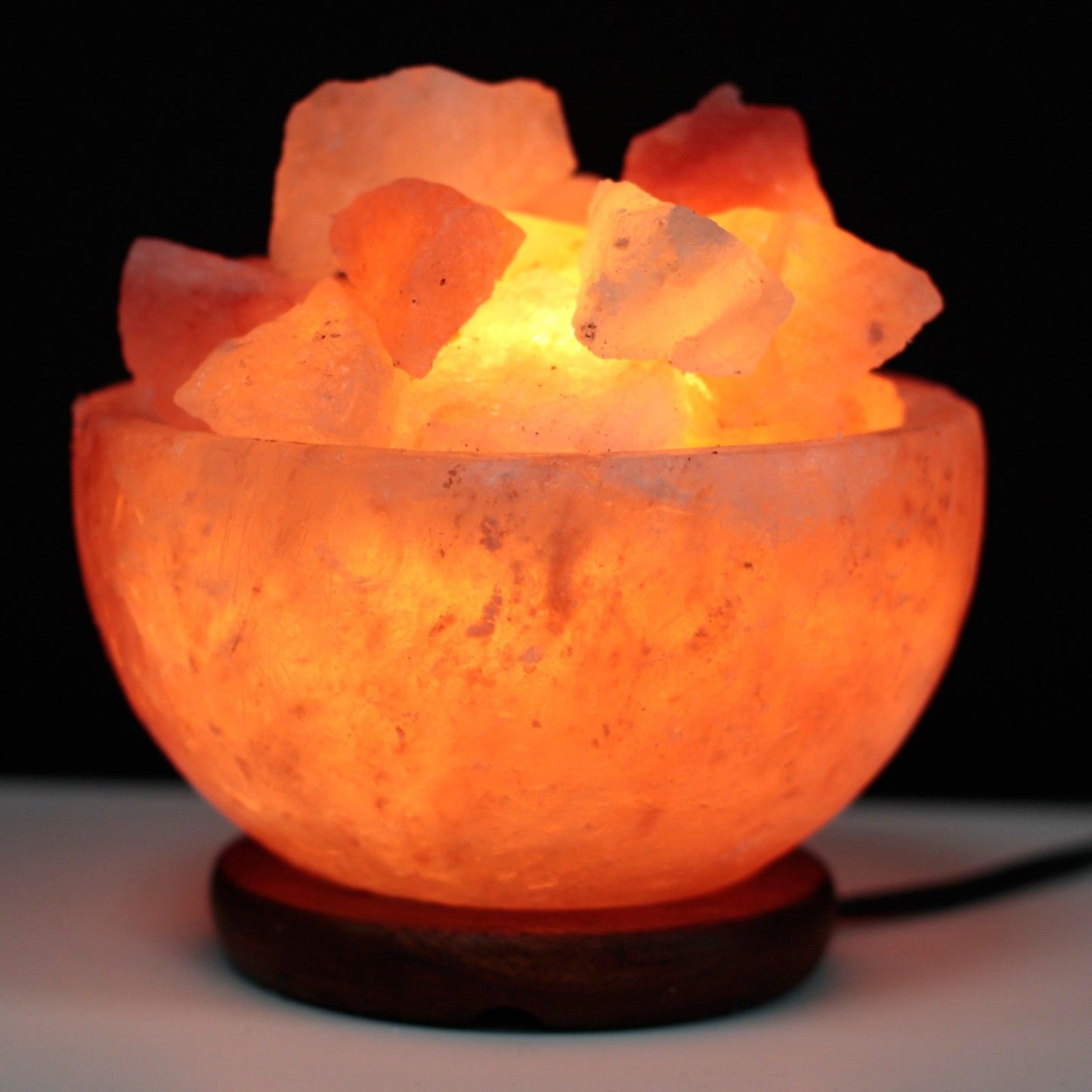 Salt Fire Bowl and Chunks, 15cm x 9cm, glowing Himalayan salt lamp with salt chunks on a wooden base