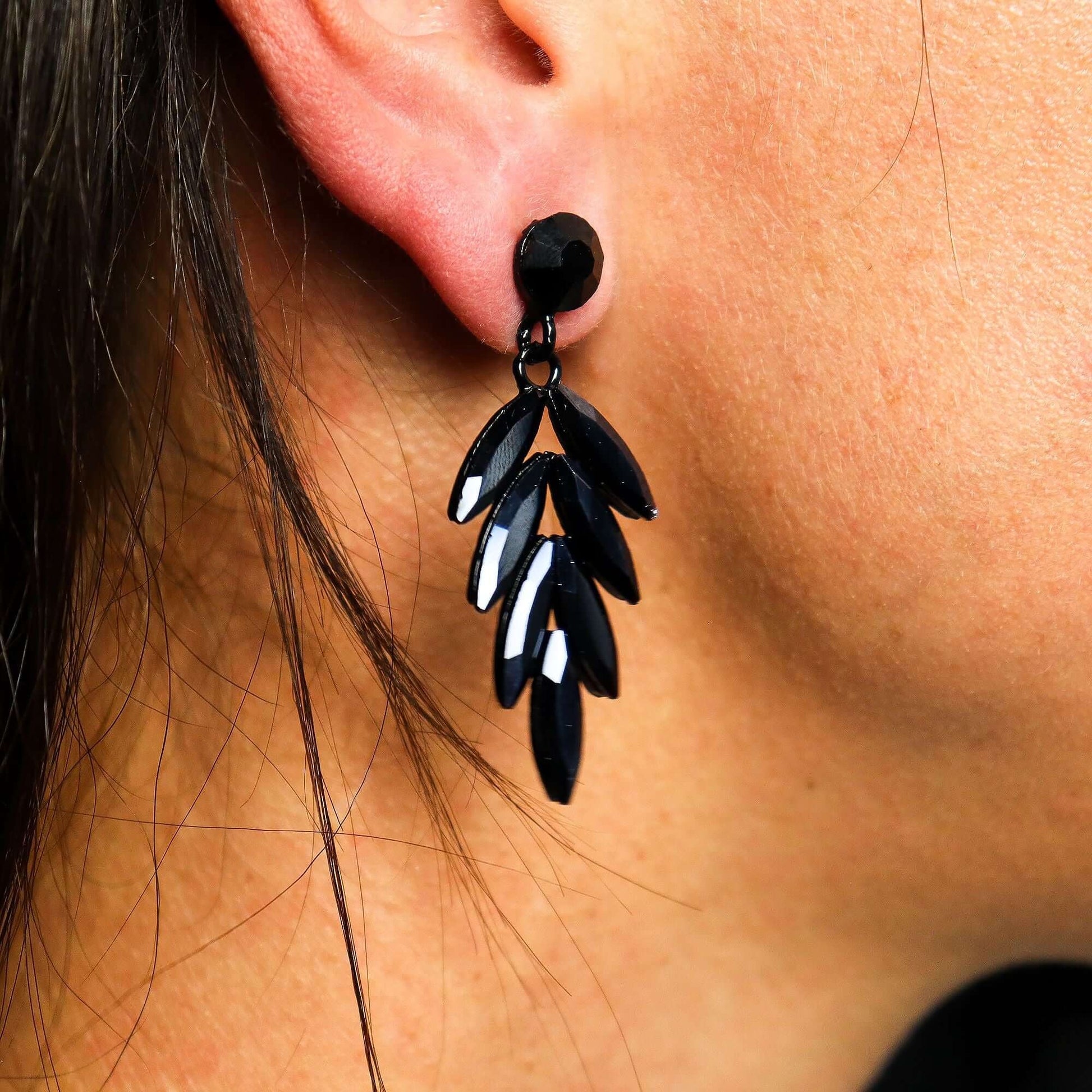 Jet Black Vintage Glass Long Drop Earrings Stainless Steel displayed on a model's ear, showcasing their elegant design.